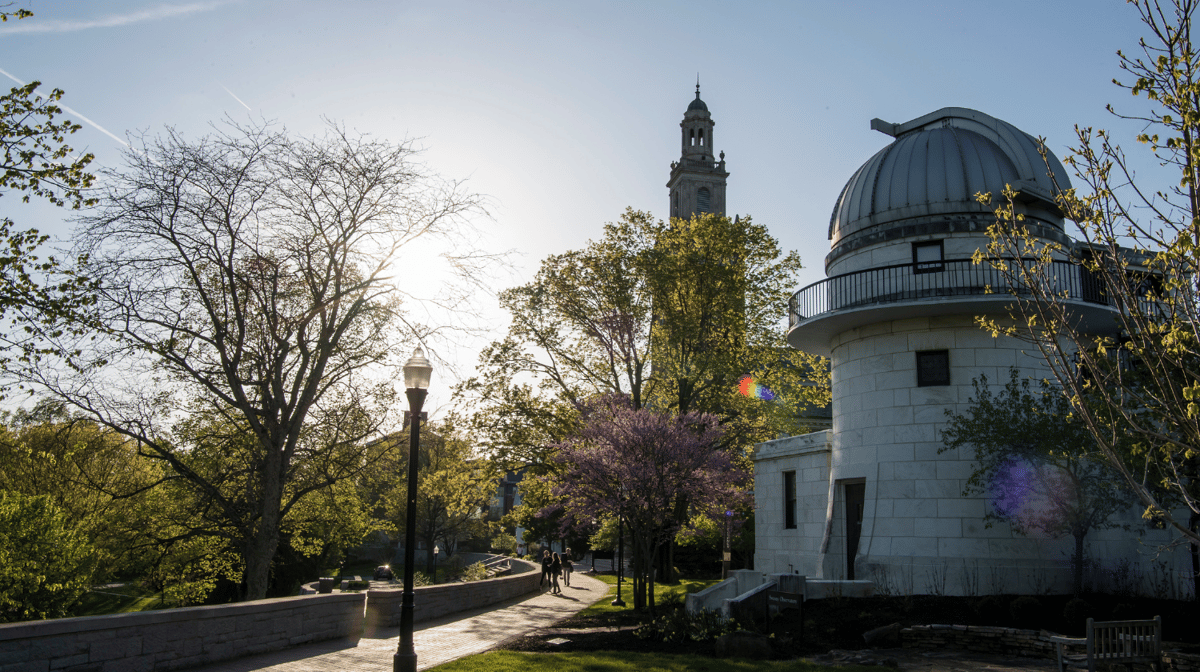 A photo of Swasey Observatory and Swasey Chapel standing against a blue sky.