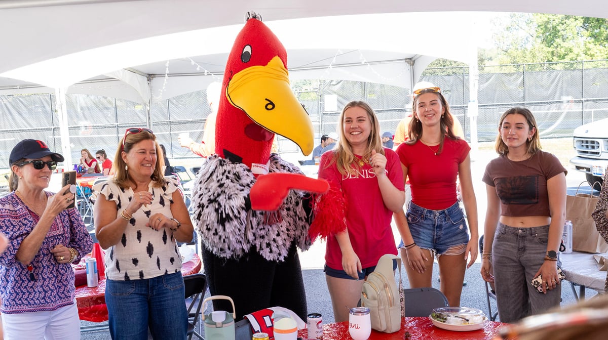 A photo of Denisonians celebrating with Buzzy at the Big Red Weekend tailgate.